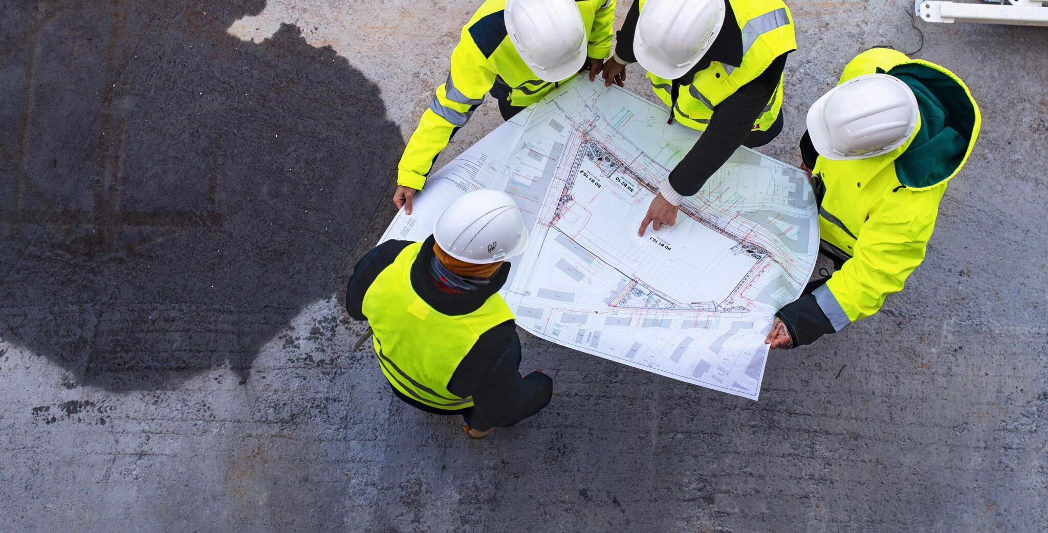 Construction services by Rudyard - Workers in high vis looking at site map